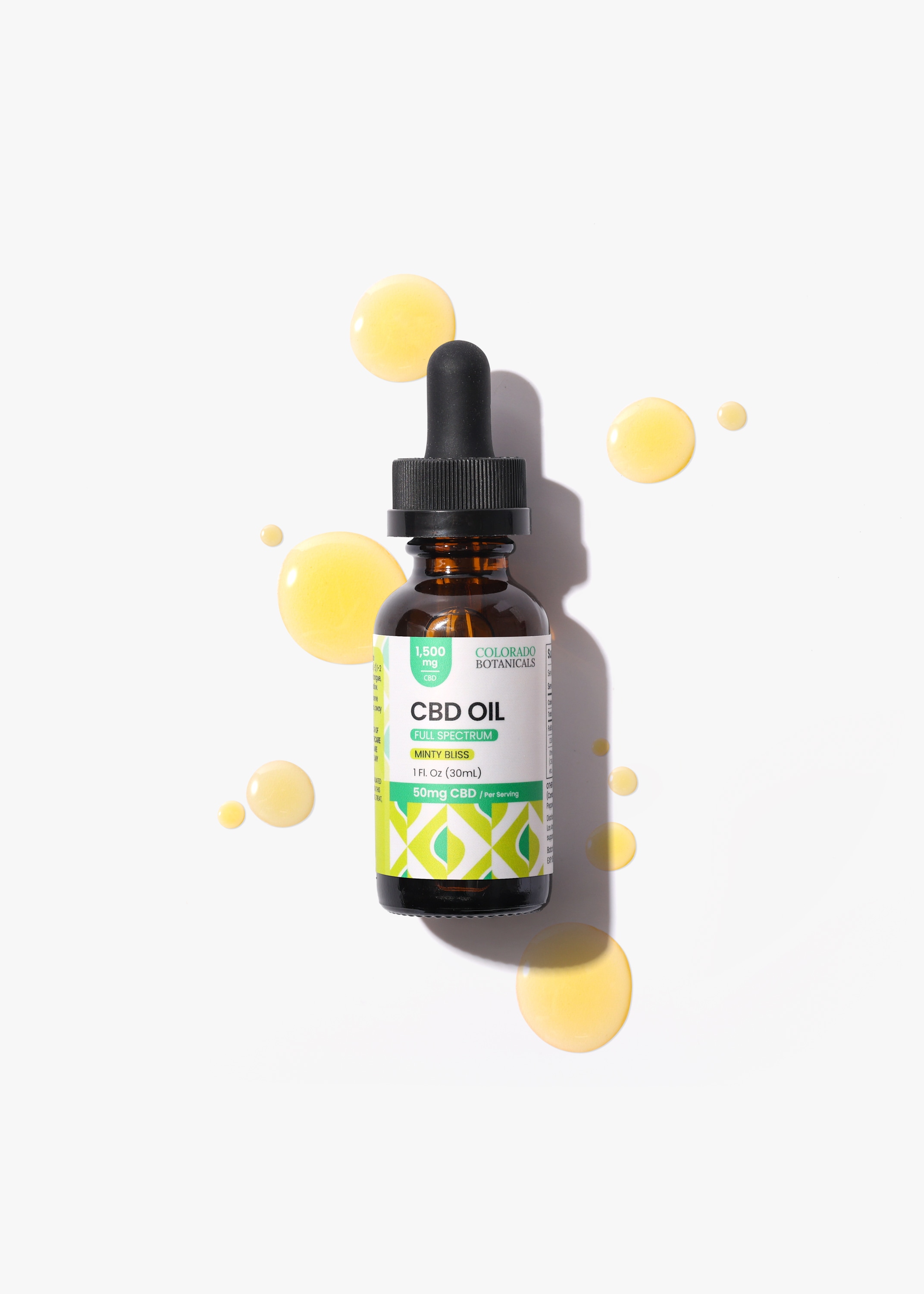 CBD oil bottle surrounded by golden oil drops