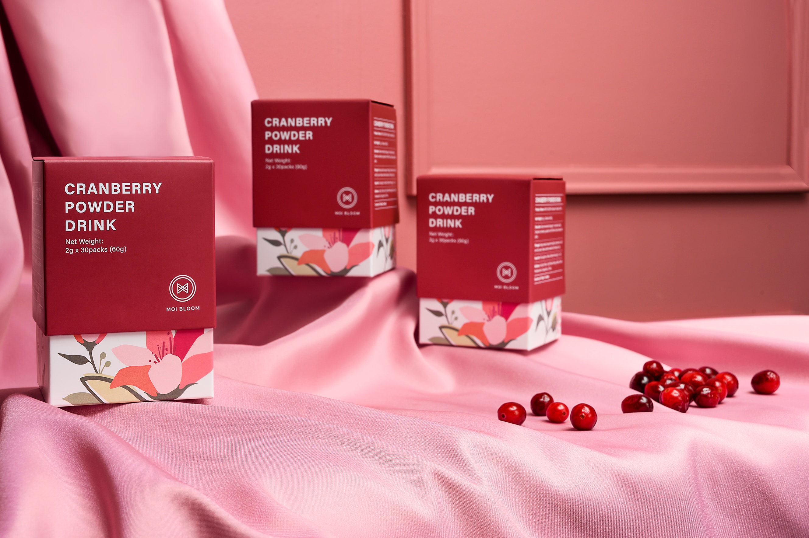Cranberry product collection on pink fabric