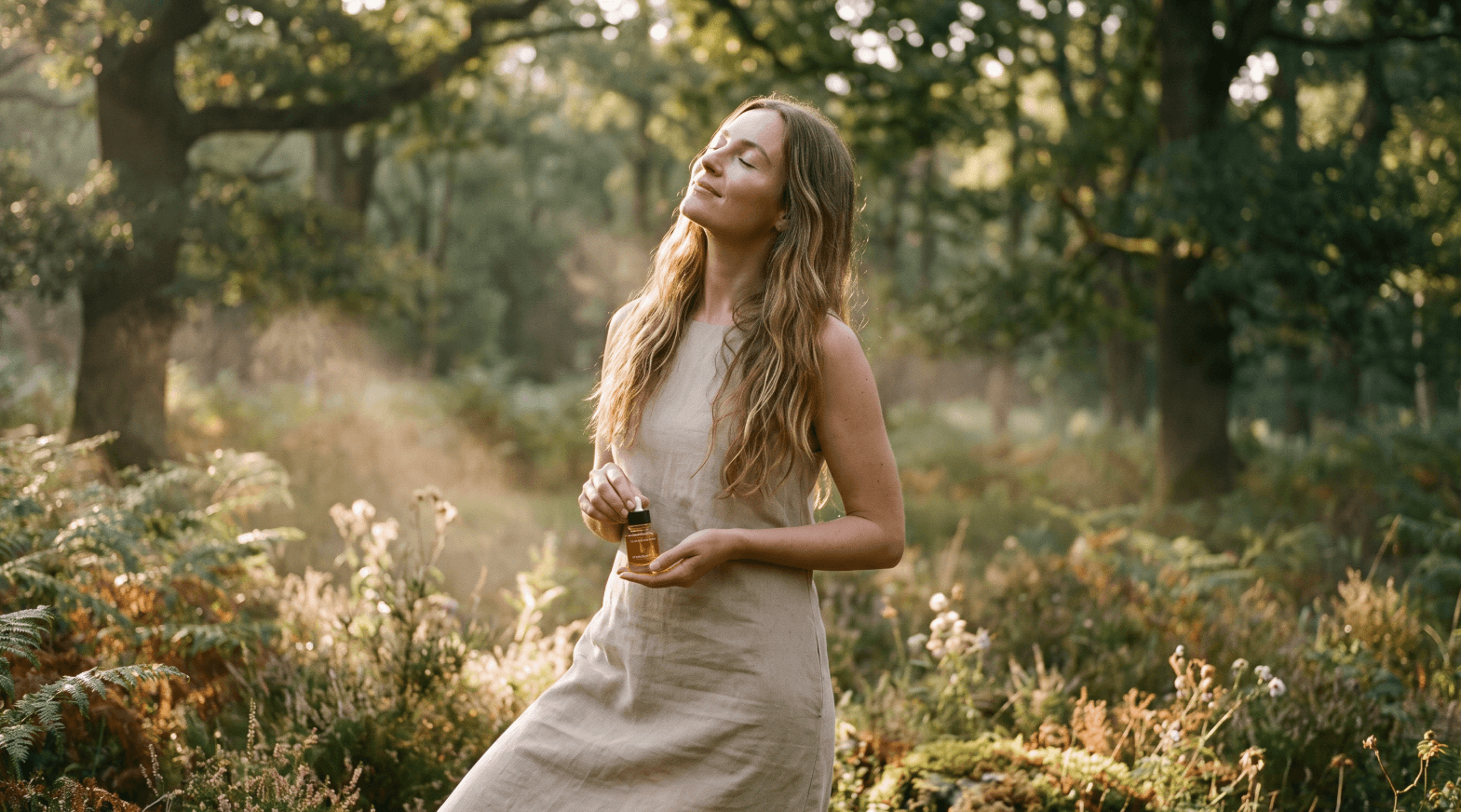 Woman holding a skincare bottle in a sunlit forest