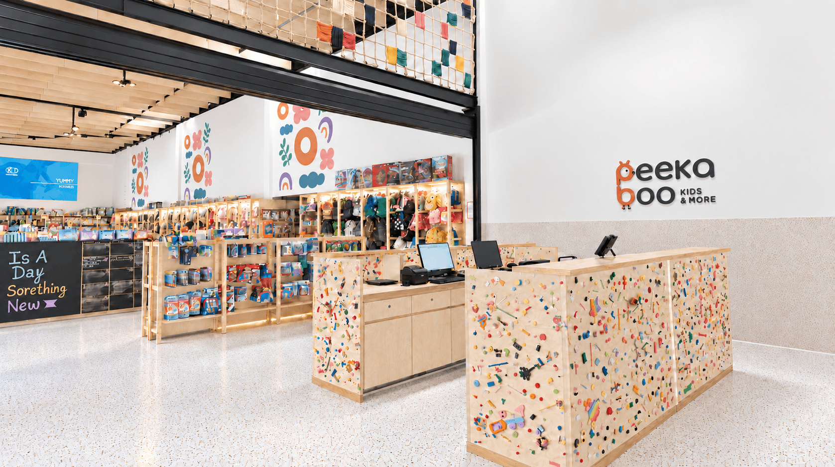 Peekaboo kids store interior with colorful displays and branded counter