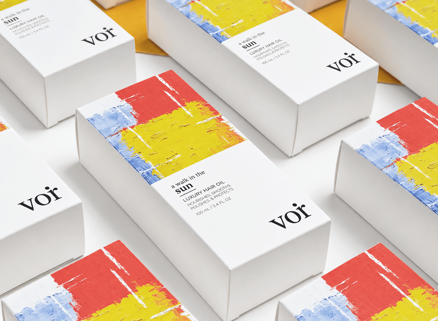 VOIR hair oil packaging with hand-painted yellow, red, and blue artwork
